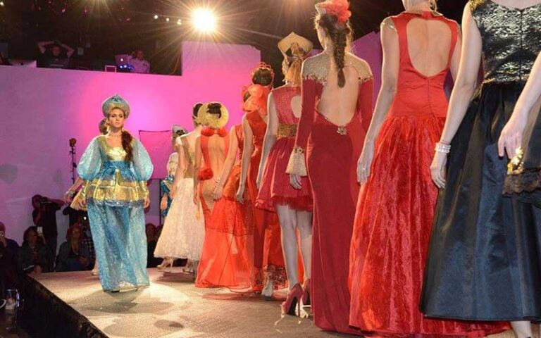 row of models on runway wearing dresses at sidney and berne davis art center fort myers