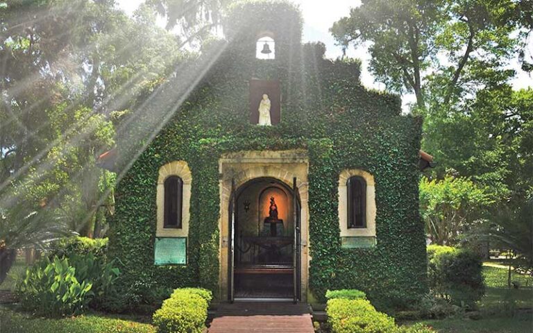 shrine exterior with ivy covered facade and icon above door at national shrine of our lady of la leche st augustine