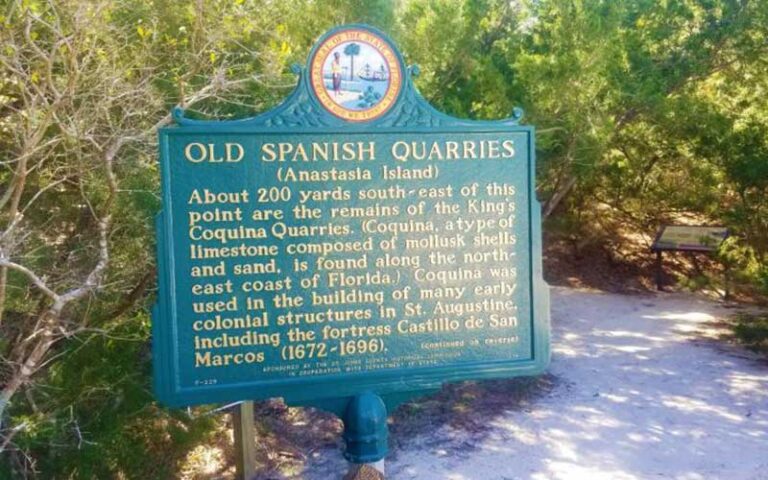 spanish quarries sign on beach path with trees at anastasia state park st augustine