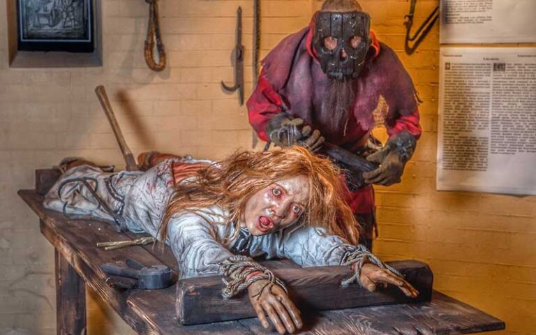 statue torturer standing over woman on flaying table at medieval torture museum st augustine