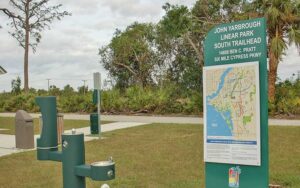 trailhead sign with water fountain and parking area at john yarbrough linear park fort myers