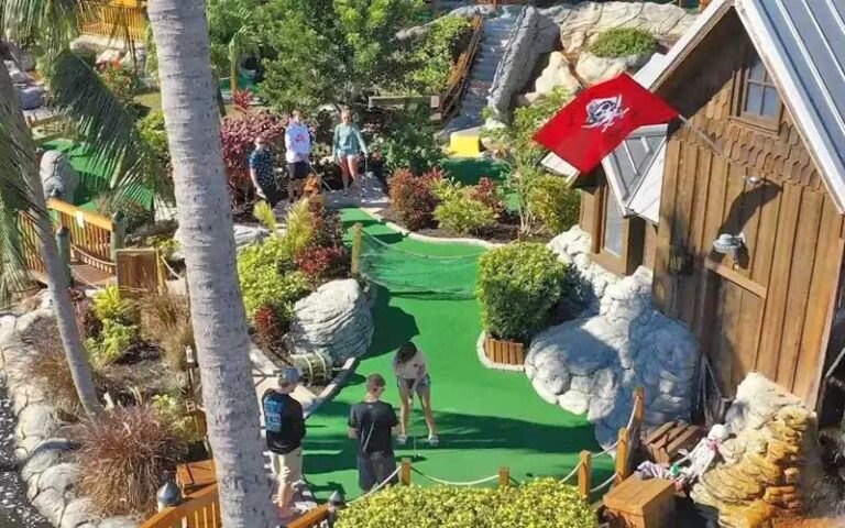 view from above of putters on separate greens at smugglers cove adventure golf fort myers beach