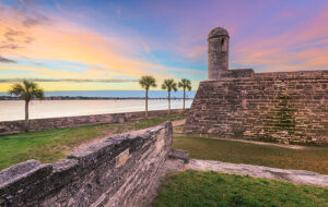 view from fortress wall of matanzas bay and bridge of lions with colorful sunset st augustine
