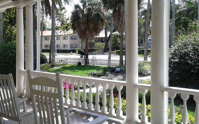 view from veranda of street with rocking chairs at burroughs home and gardens fort myers