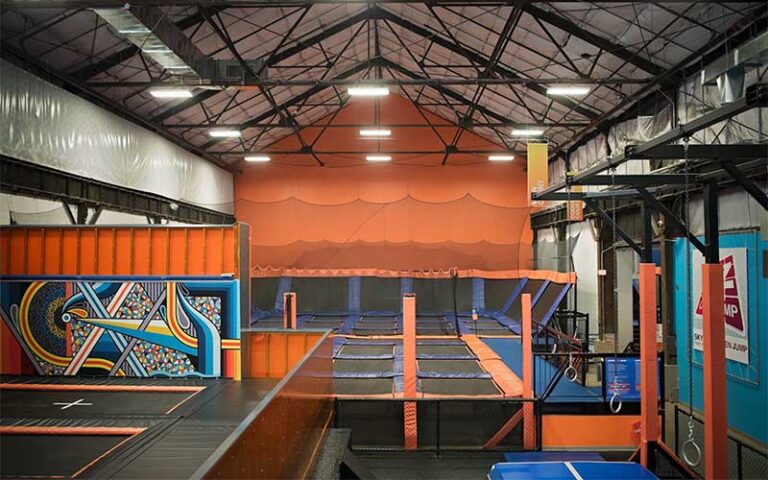 warehouse sized trampoline park with orange and blue jumping areas at sky zone trampoline park fort myers