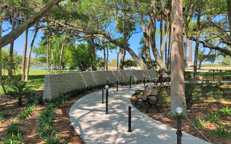 wooded pathway through garden along low wall at national shrine of our lady of la leche st augustine