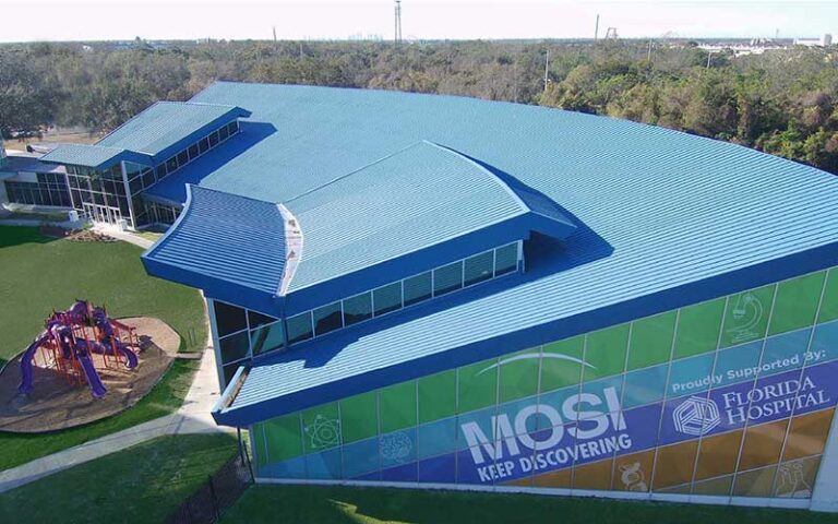aerial view over large exhibit building with playground at mosi museum of science industry tampa