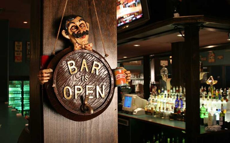 bar is open sign hanging from post with bar in background at livingstones amusements sarasota