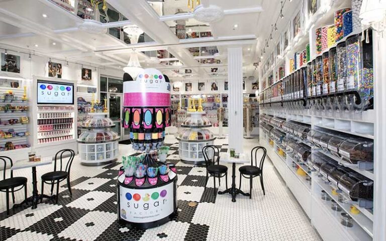 black and white tiled cafe interior with candy dispensers at sugar factory icon park orlando