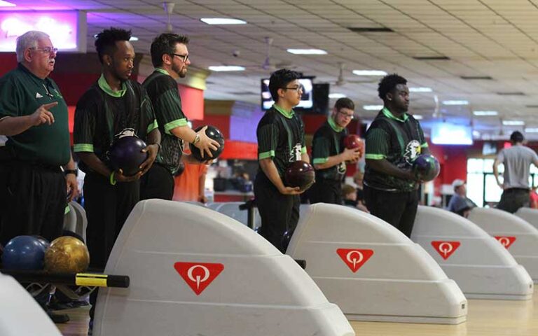 bowling league with matching shirts prepping at alley at sarasota lanes bowling