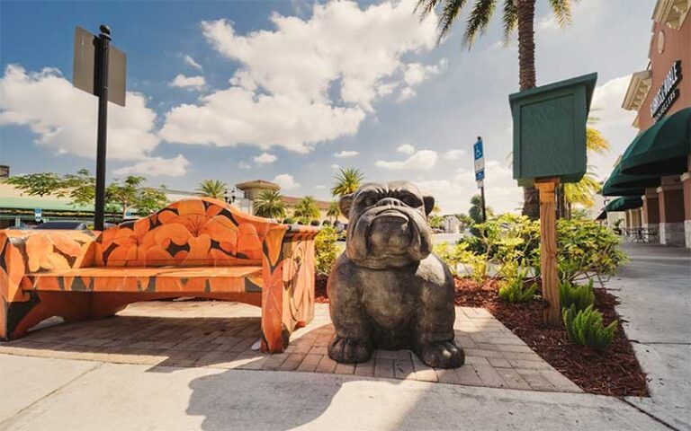 bulldog statue next to park bench painted with flowers in outdoor shopping plaza at shops at pembroke gardens ft lauderdale