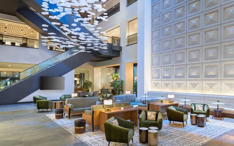 cathedral ceiling lobby with floating staircase and seating area at jw marriott tampa water street