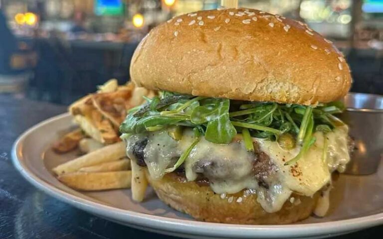 cheeseburger with greens on bun at whiskey cake tampa