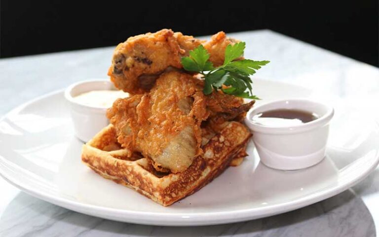 chicken and waffle entree at sugar factory icon park orlando