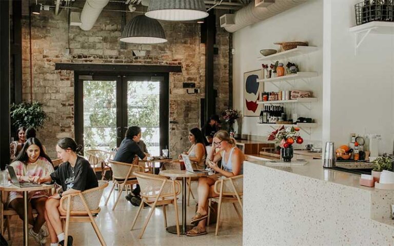 coffee shop industrial style interior with patrons at willas and willas provisions tampa