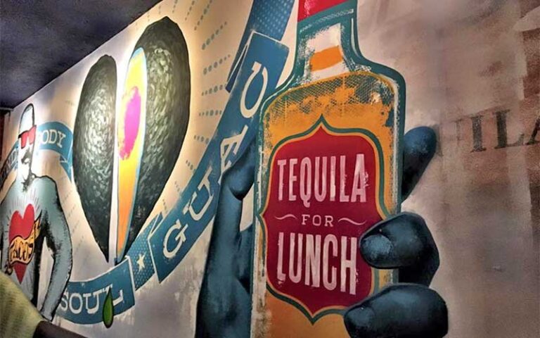 colorful mural on restaurant wall with tequila bottle and avocado at green lemon tampa