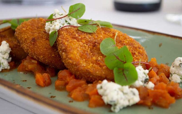 crab cakes with ricotta and garnish at spinners rooftop grille st pete beach