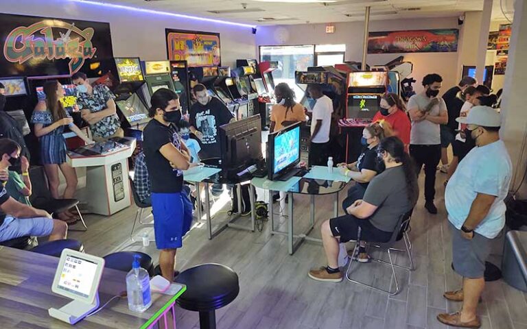 crowded arcade center with customers playing games and watching at retro zone arcade fort myers