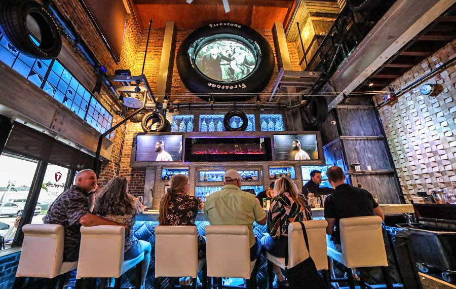 crowded bar with historic tire themed industrial decor the firestone fort myers