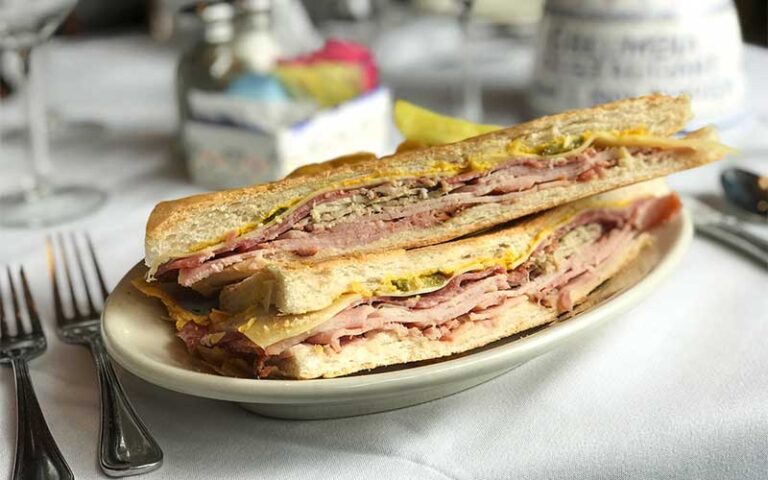 cuban sandwich on plate with table setting at columbia restaurant ybor city tampa
