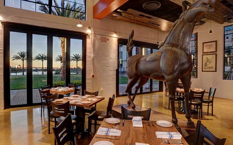 dining room with river view and horse sculpture at ulele tampa