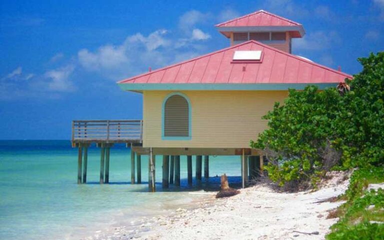 dock building on beach with red roof at honeymoon island state park dunedin