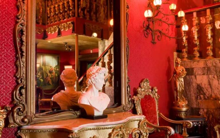 foyer area with marble bust and red walls at berns steak house tampa