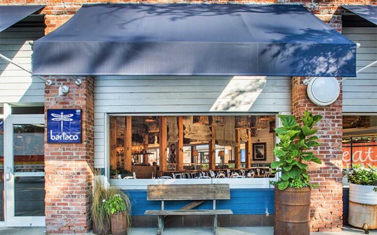 front exterior of restaurant with blue awning and sign at bartaco tampa