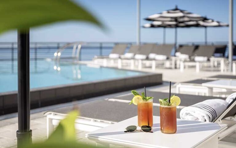 glasses of iced tea on patio furniture poolside at the current hotel tampa