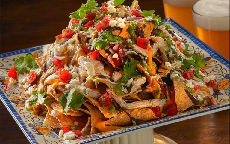 huge platter of loaded chicken nachos at planet hollywood disney springs