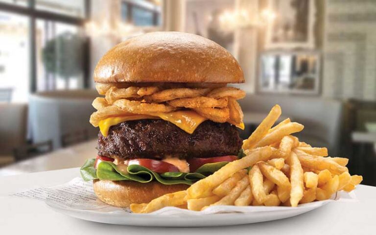 huge stacked burger with fries at sugar factory icon park orlando