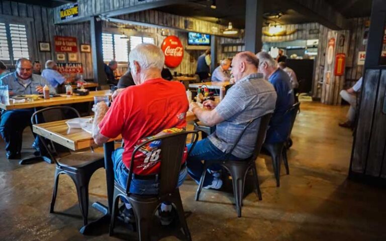 interior of rustic diner with men eating at table at jimbos pit bar b q tampa