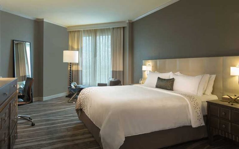 king guestroom with drawn curtains over window at renaissance tampa international plaza hotel