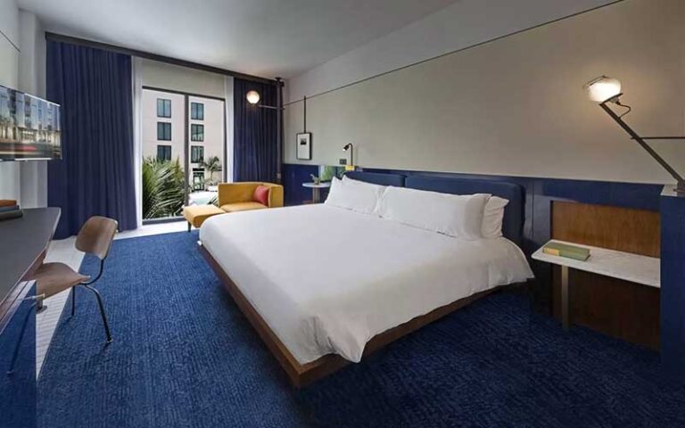 king size bed guestroom with blue accents at hotel haya ybor city tampa