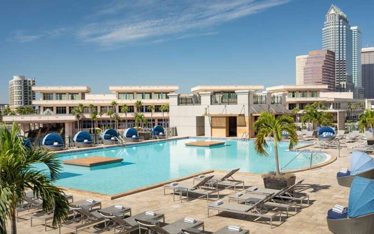 large pool terrace with blue accents and city skyline at tampa marriott water street