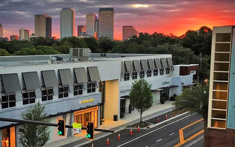 lighted buildings with sun setting and high rise at hyde park village tampa