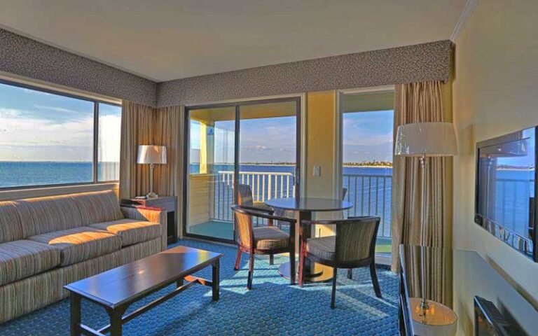 living room of suite with balcony and water views at sailport waterfront suites tampa