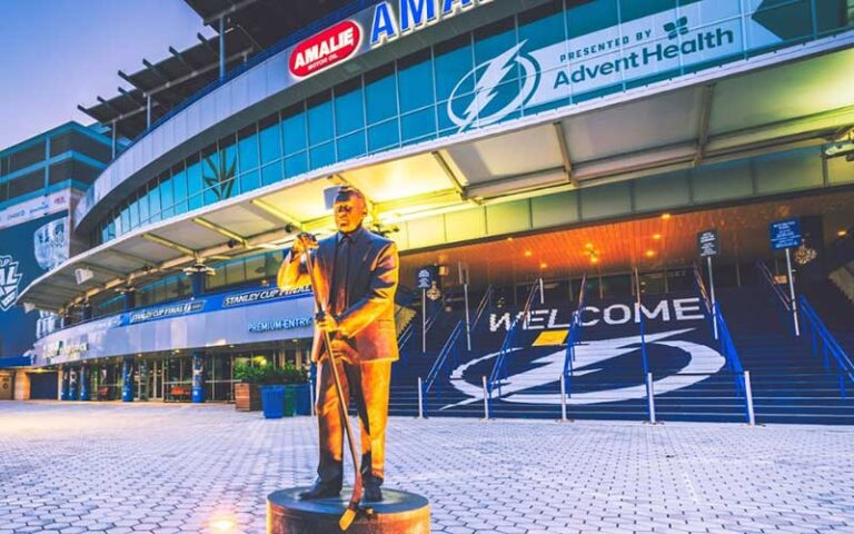 night exterior front entrance with statue at amalie arena tampa