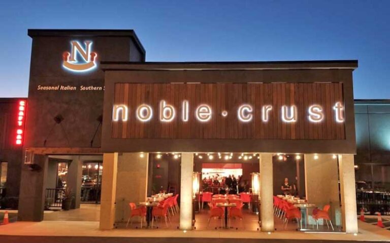 night front exterior with lighted sign at noble crust tampa
