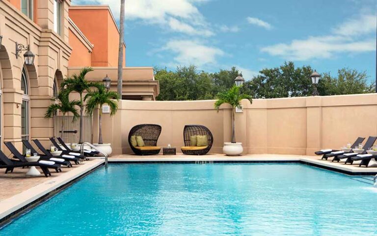 outdoor pool and terrace with wicker lounges at renaissance tampa international plaza hotel
