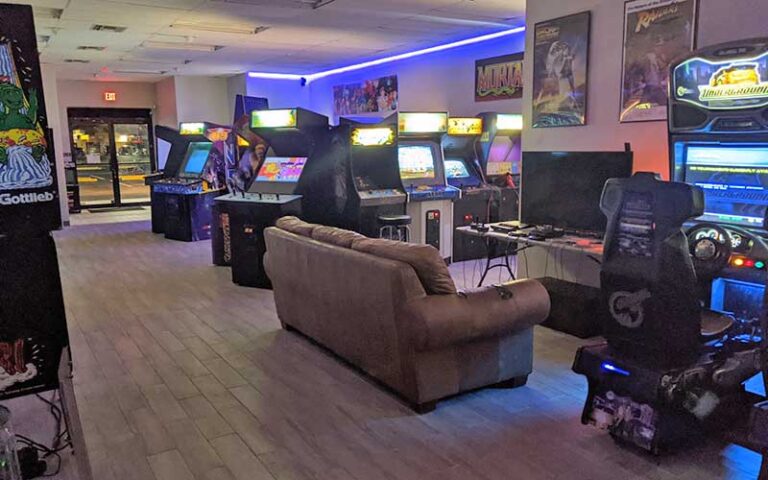 roomy arcade lounge area with sofa and video games at retro zone arcade fort myers