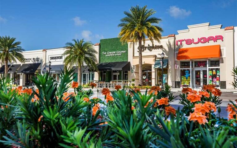 row of outdoor store fronts with flowery hedge at shops at pembroke gardens ft lauderdale
