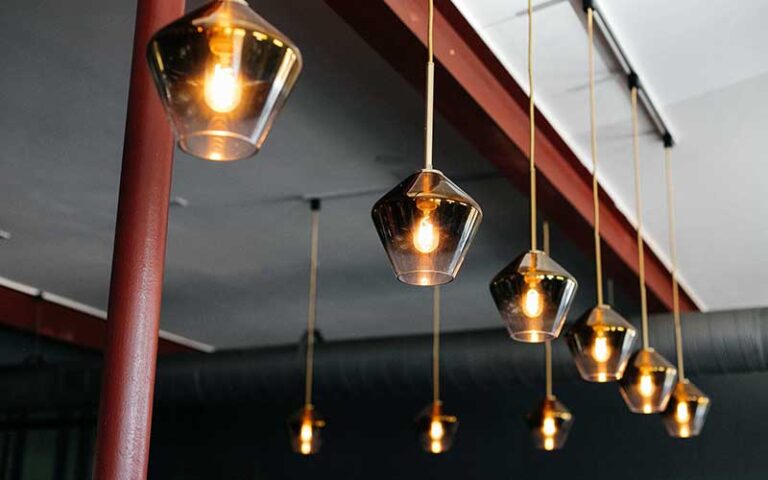 row of tinted glass pendant lights at rooster the till tampa