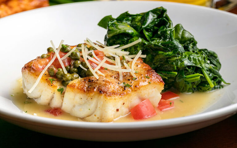 seafood with spinach on white plate at village tavern shops pembroke gardens ft lauderdale