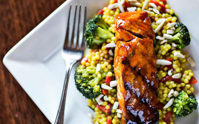 seared salmon on a bed of rice and broccoli at village tavern shops pembroke gardens ft lauderdale