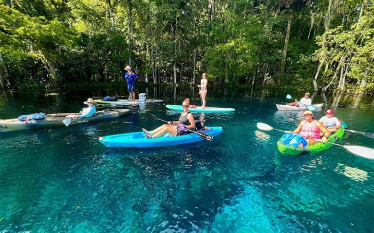 several people in canoes kayaks with guide at epic paddle adventures orlando