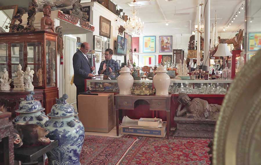 store clerks at counter in antique shop at sarasota trading company