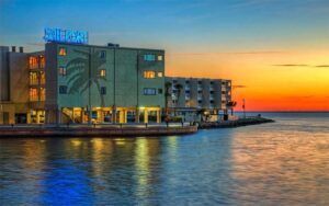 sunset with silhouetted hotel and sign at sailport waterfront suites tampa