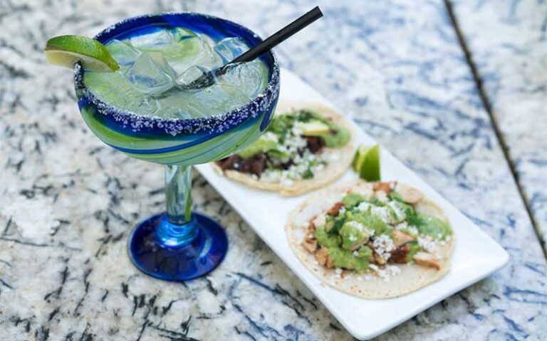 tacos with margarita in blue designed glass at miguelitos taqueria y tequilas tampa