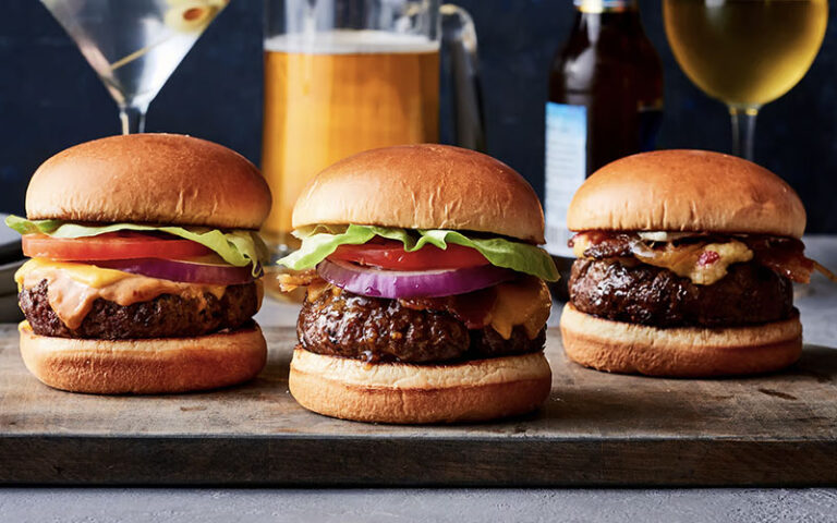 three burgers with drinks on a bar at village tavern shops pembroke gardens ft lauderdale